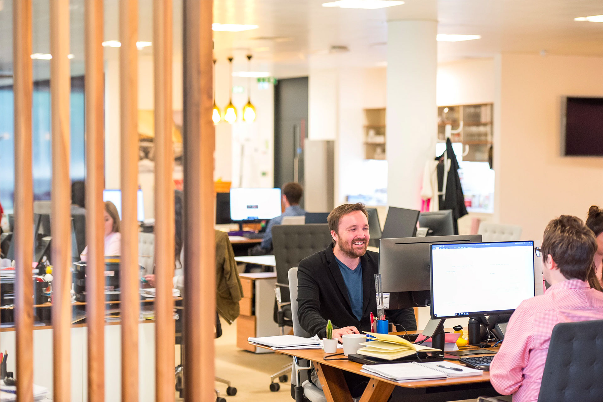 Some happy employees working on computers